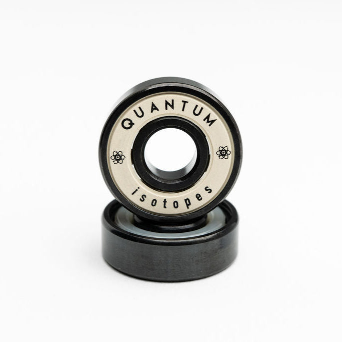 Two black bearings with 'Quantum Isotopes' branding on a white background
