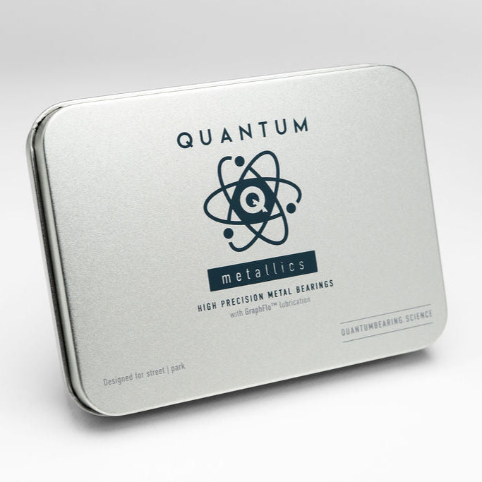 Metallic packaging with 'Quantum Metallics' branding on a white background