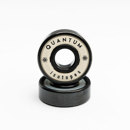 Two black bearings with 'Quantum Isotopes' branding on a white background