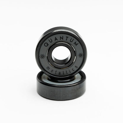 Two black bearings with 'Quantum Metallics' branding on a white background